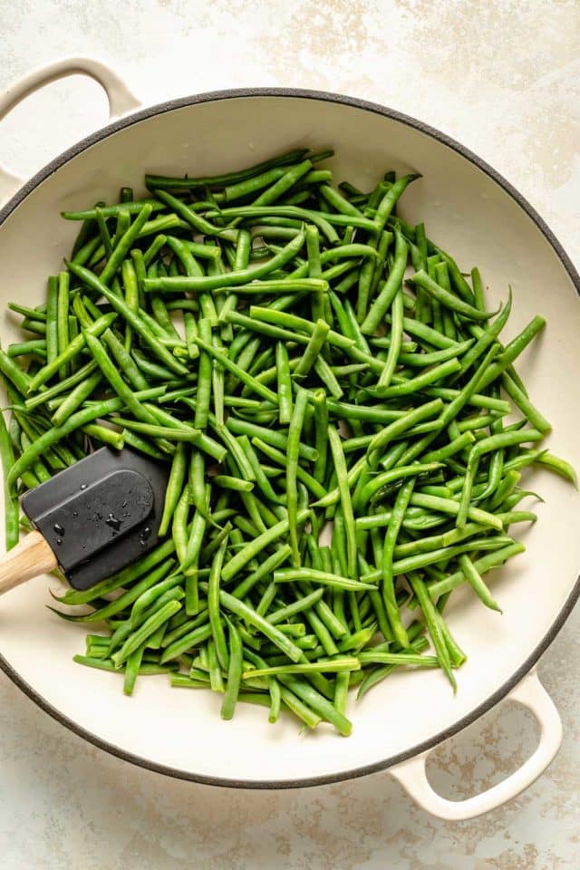cooking fresh green beans in a skillet