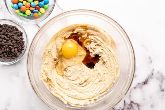 adding egg and vanilla to cookie dough batter