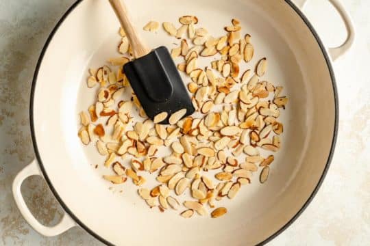 toasting sliced almonds in a pan