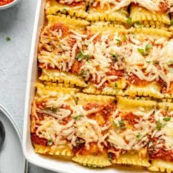 Lasagna roll ups in a large white dish.