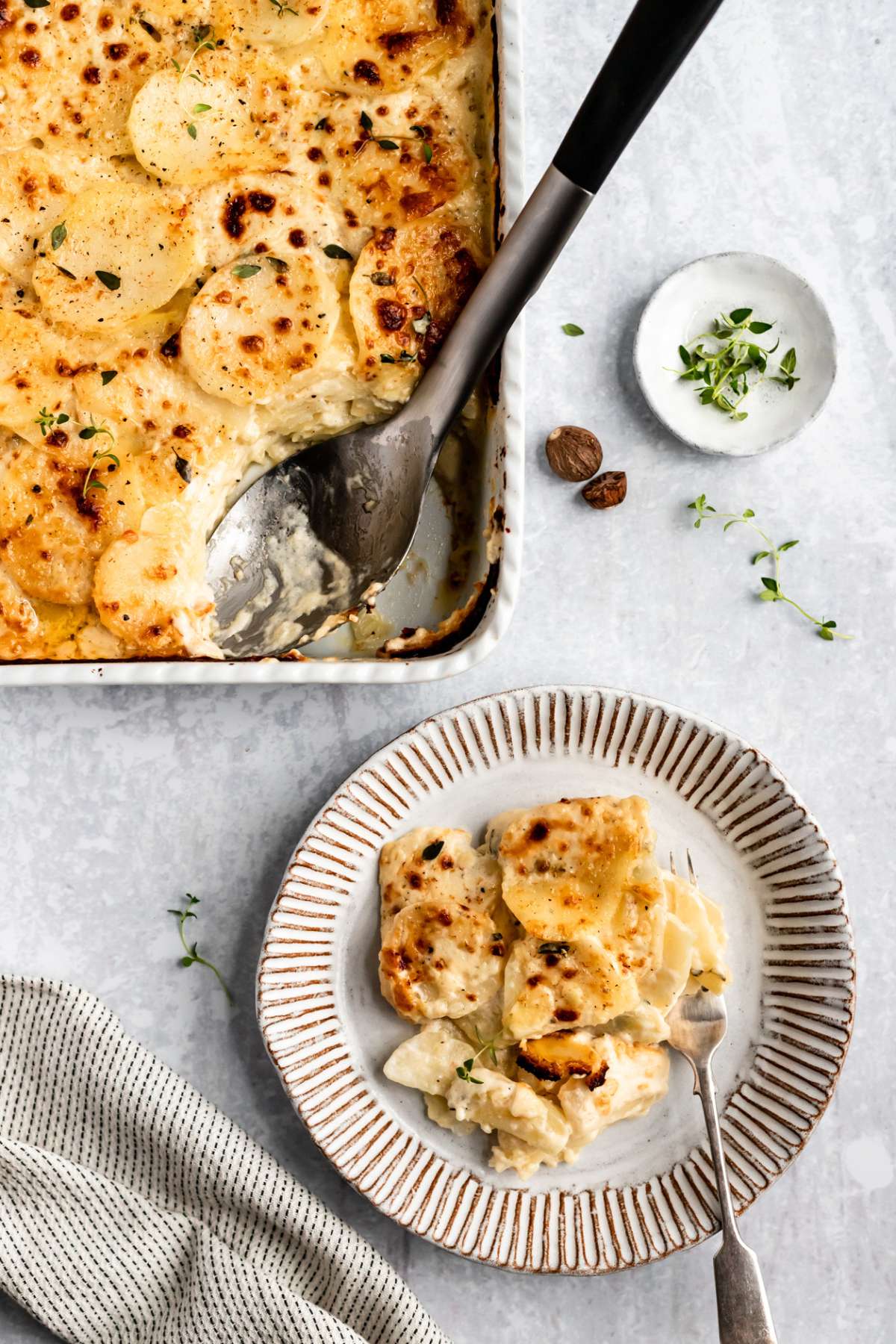 Cheesy scalloped potatoes served on a small plate.