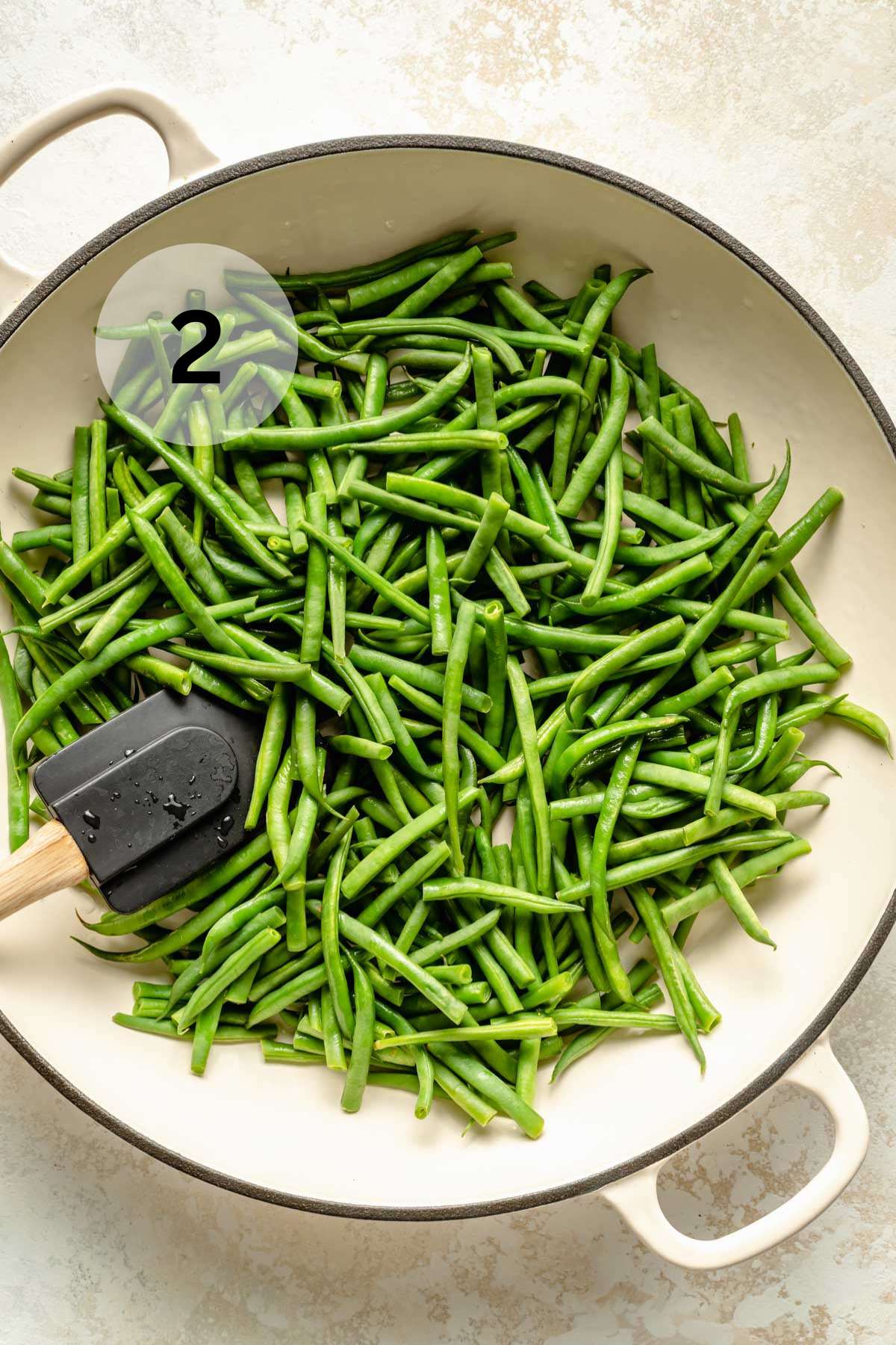 Cooking fresh green beans in a skillet.