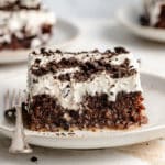 Slice of better than sex cake topped with Oreo crumbles.