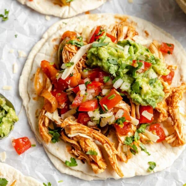Shredded chicken with Pico de Gallo and guacamole on a flour tortilla.