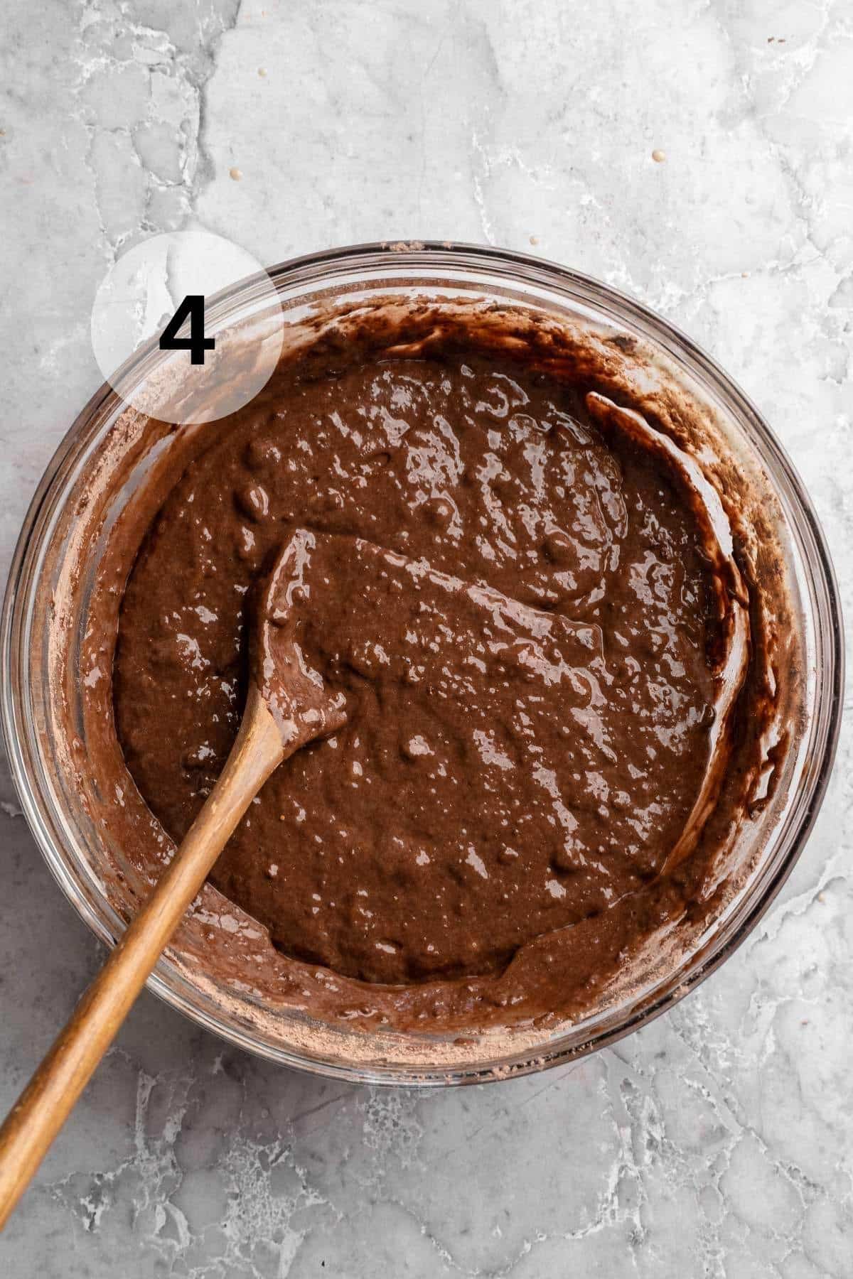 Stirring chocolate banana muffin batter.