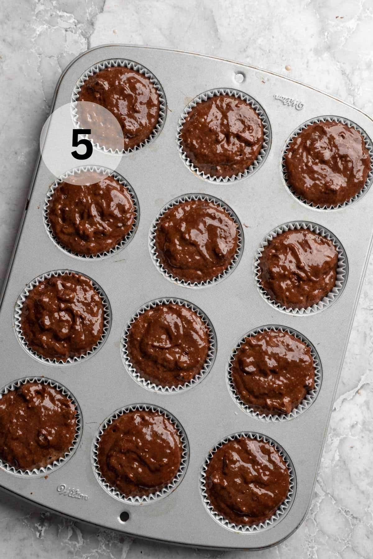 Muffin batter in a muffin pan.