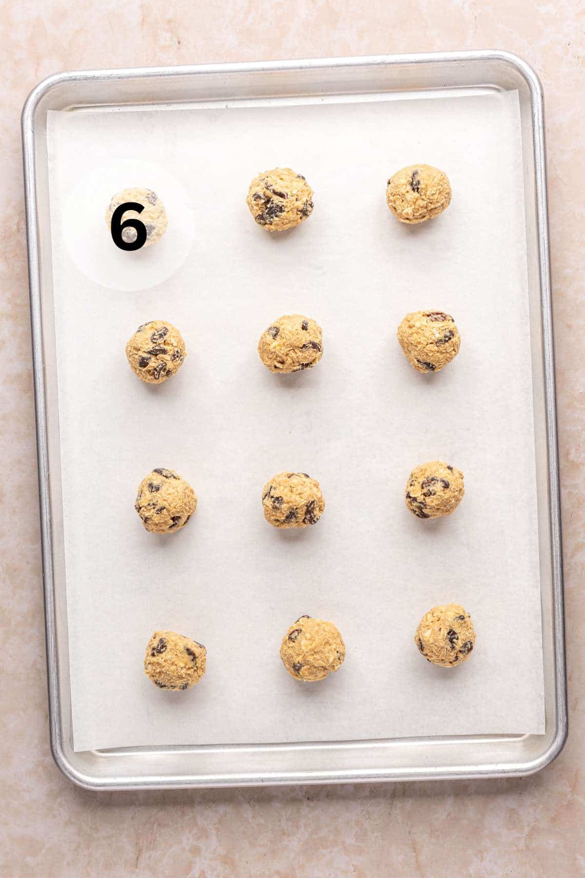 Dough balls on a parchment lined cookie sheet.