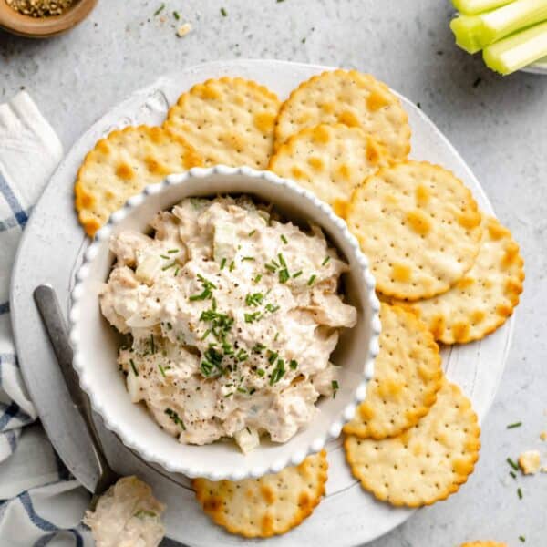 Tuna salad in a bowl served with crackers.