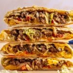 Four halves of a Crunchwrap supreme stacked.