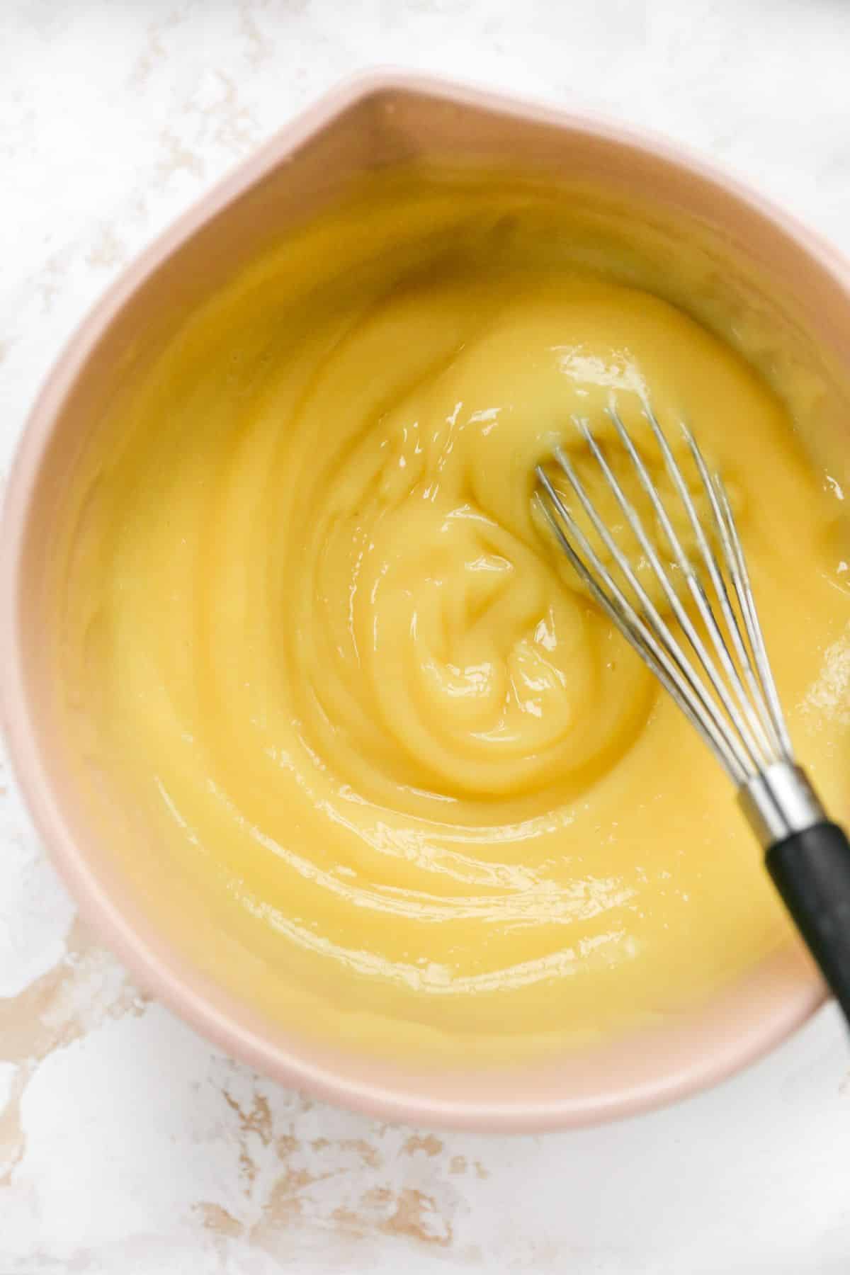 Whisking vanilla pudding with milk.