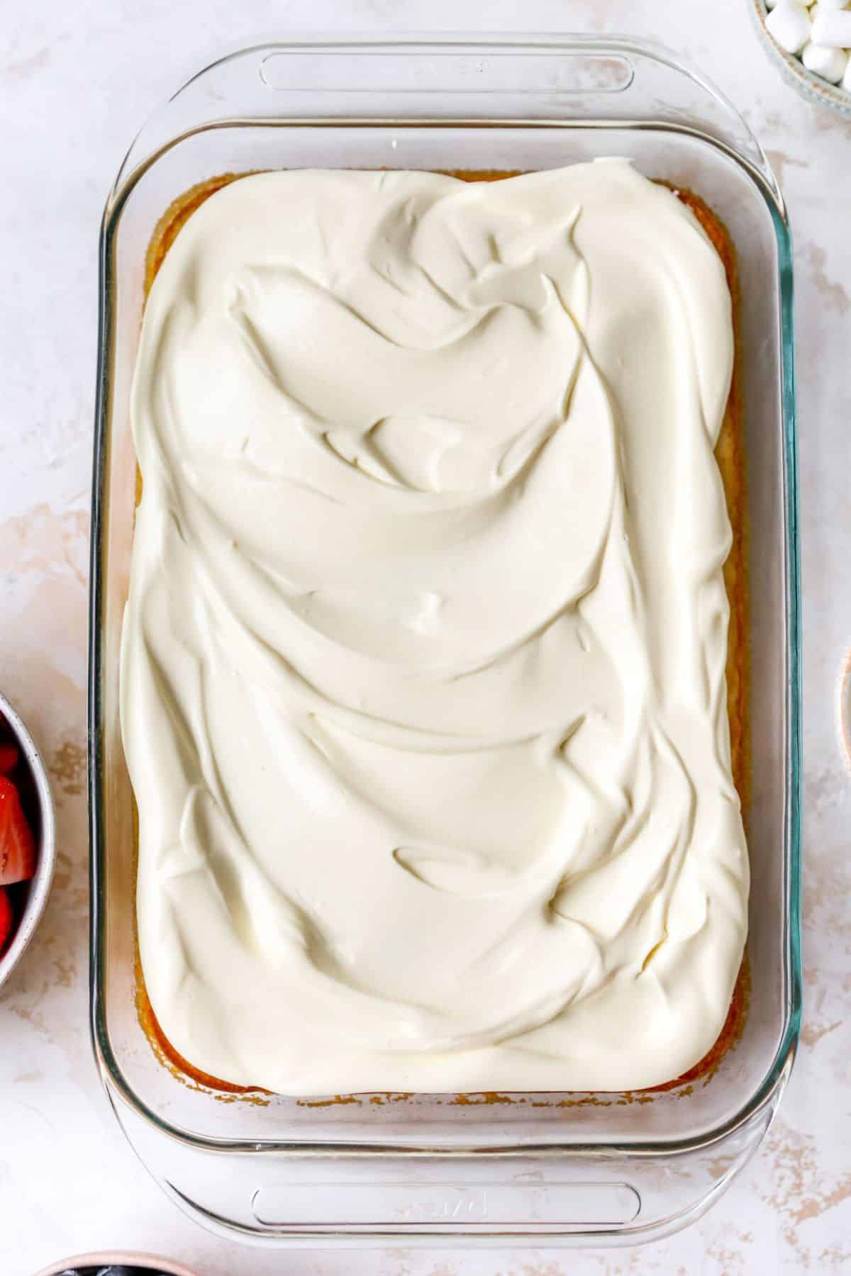 Whipped topping spread over a sheet cake.