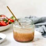 Poppy seed dressing mixed in a small glass jar.