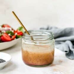Poppy seed dressing mixed in a small glass jar.