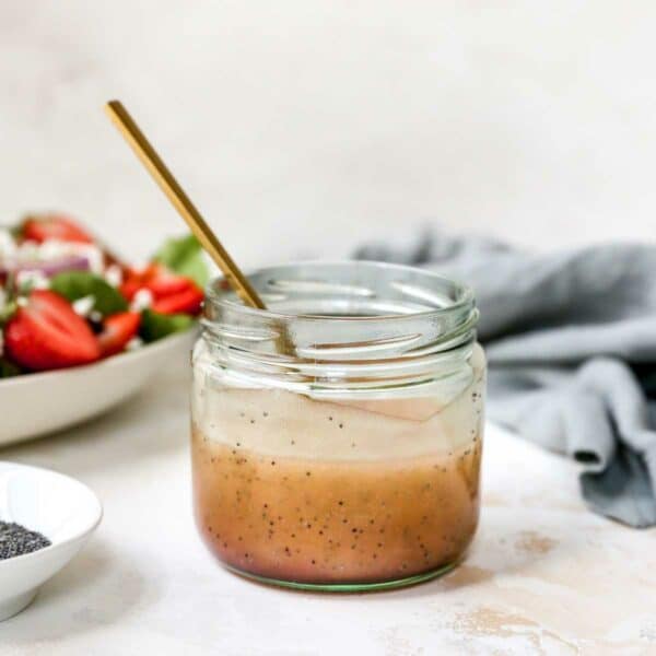 Poppy seed dressing mixed in a small glass jar.