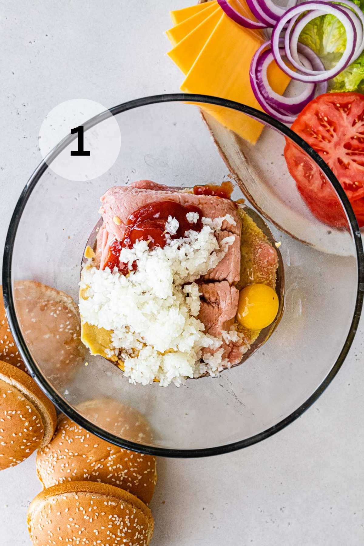 Ground turkey, egg, breadcrumbs, ketchup and mustard in a bowl.