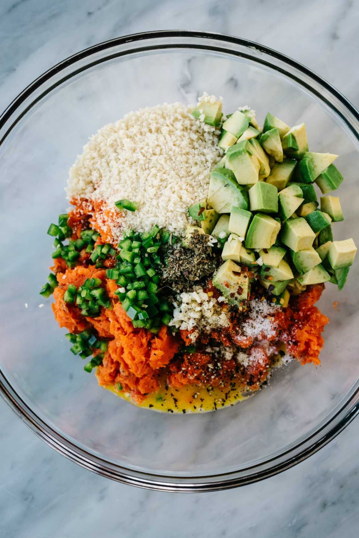Mixing breadcrumbs, avocado, salmon and seasonings in a large bowl.