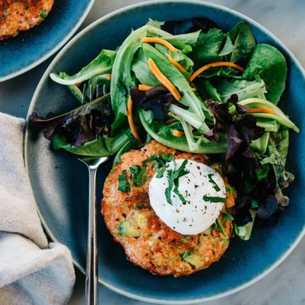 Salmon burger served with greens and homemade ranch dressing.