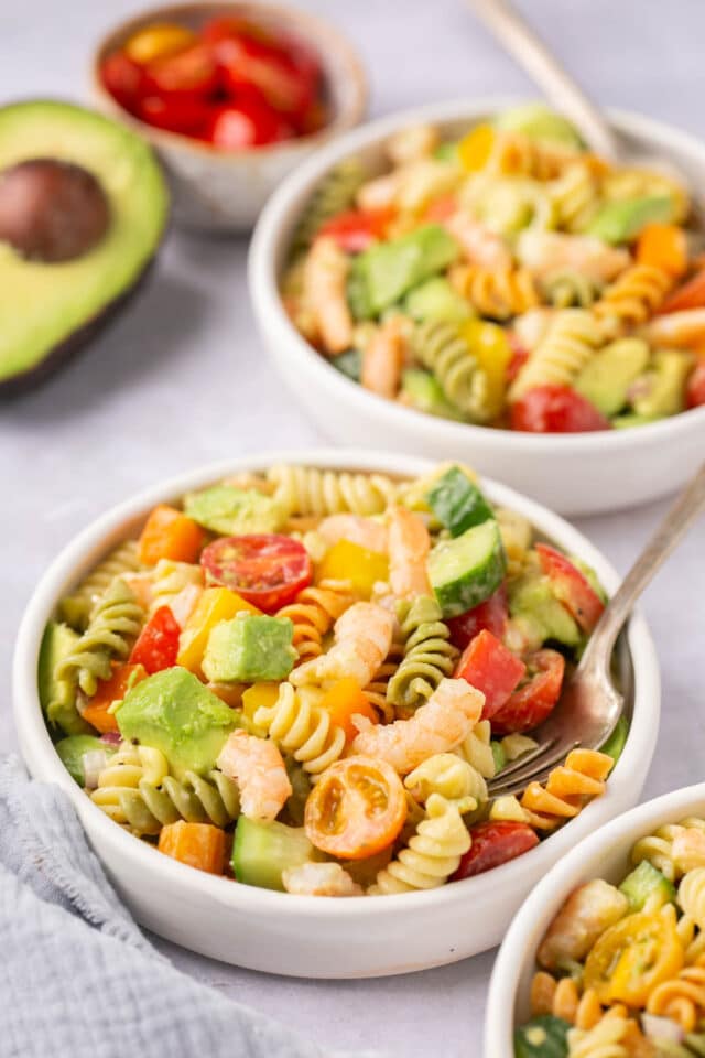 Tri-color Pasta Salad served in a small white bowl with a fork.