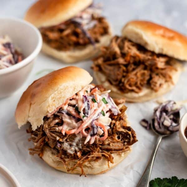 Slow cooker pulled pork sandwiches with coleslaw.