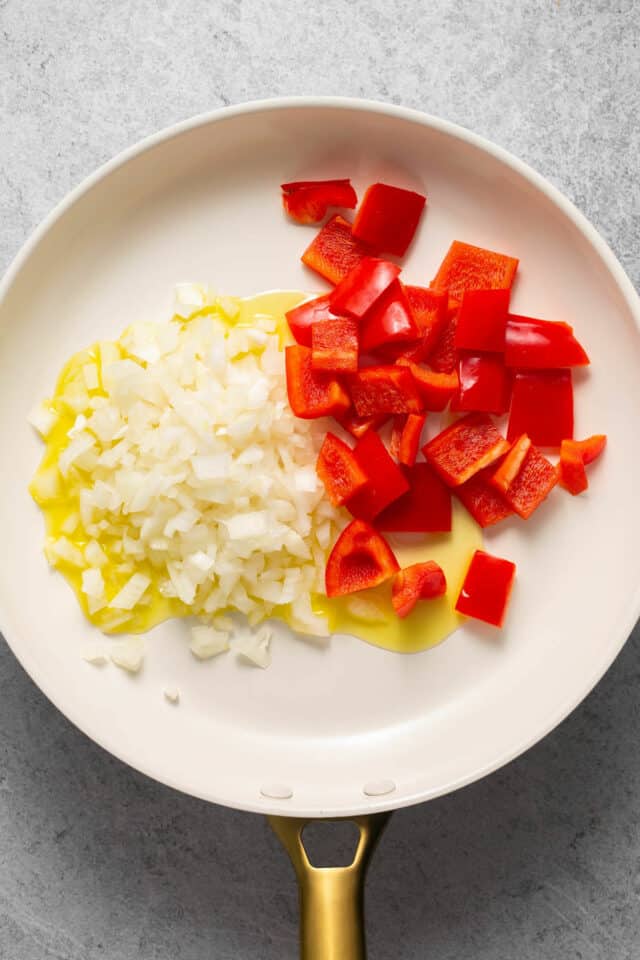 Add diced onion and bell pepper to pan with olive oil.