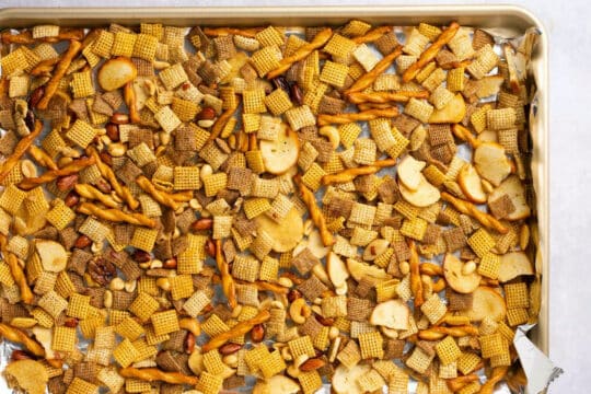 Add Chex snack mix to a large baking sheet lined with foil.