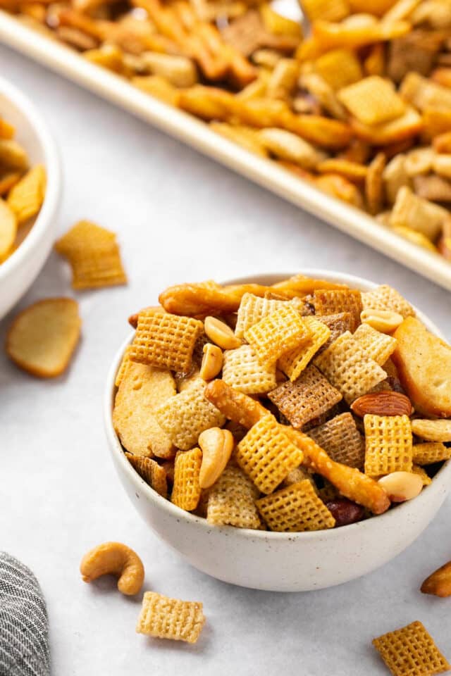 Chex party mix in a small white bowl.