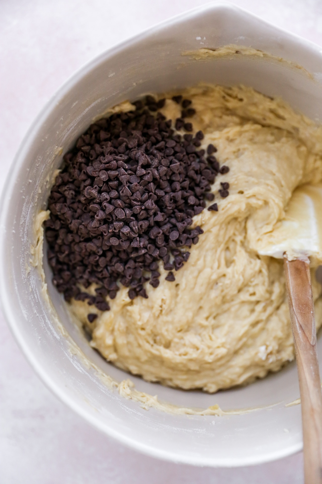 Adding chocolate chips to muffin batter.