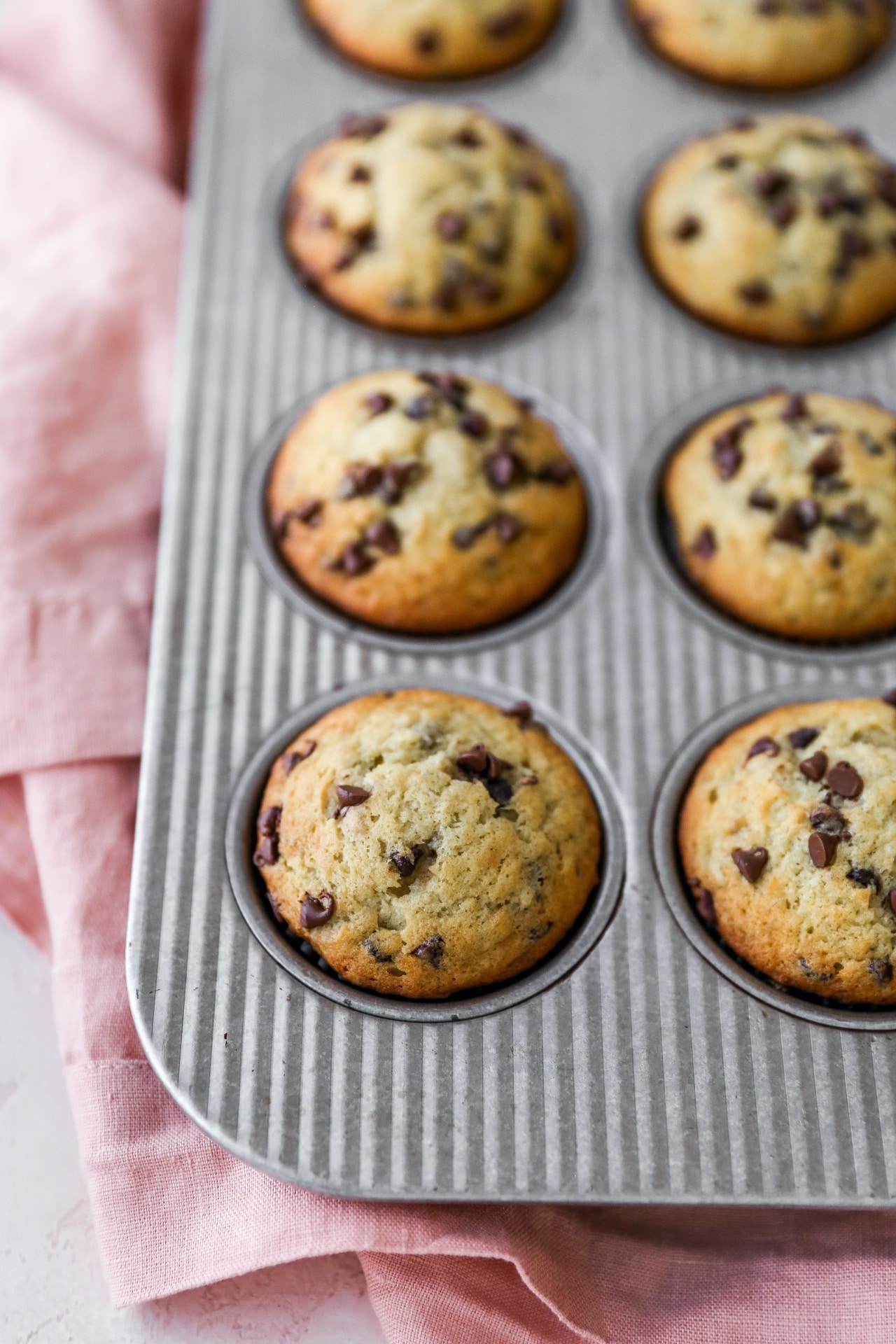 Muffins with chocolate chip in a muffin tin. 