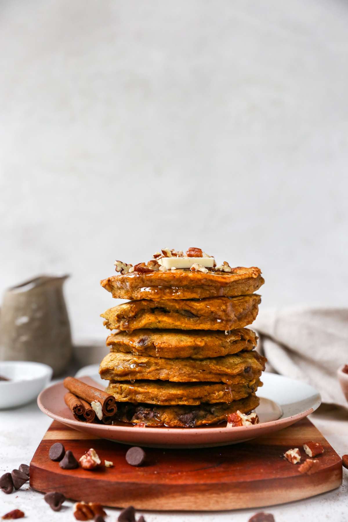 Stack of pumpkin pancakes drizzled with maple syrup.