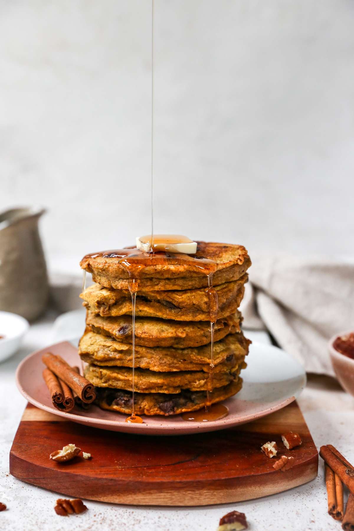 Stack of pancakes with syrup dripping down the side.