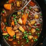 Vegetable beef soup cooking in a slow cooker.