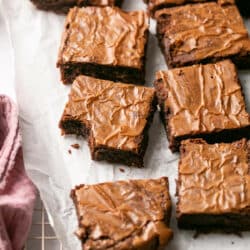 Brownies on parchment paper, cut into squares.