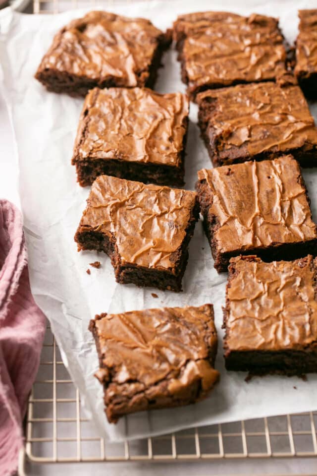 Brownies on parchment paper, cut into squares. 