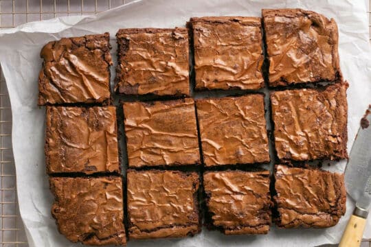 Brownies cut on parchment paper.