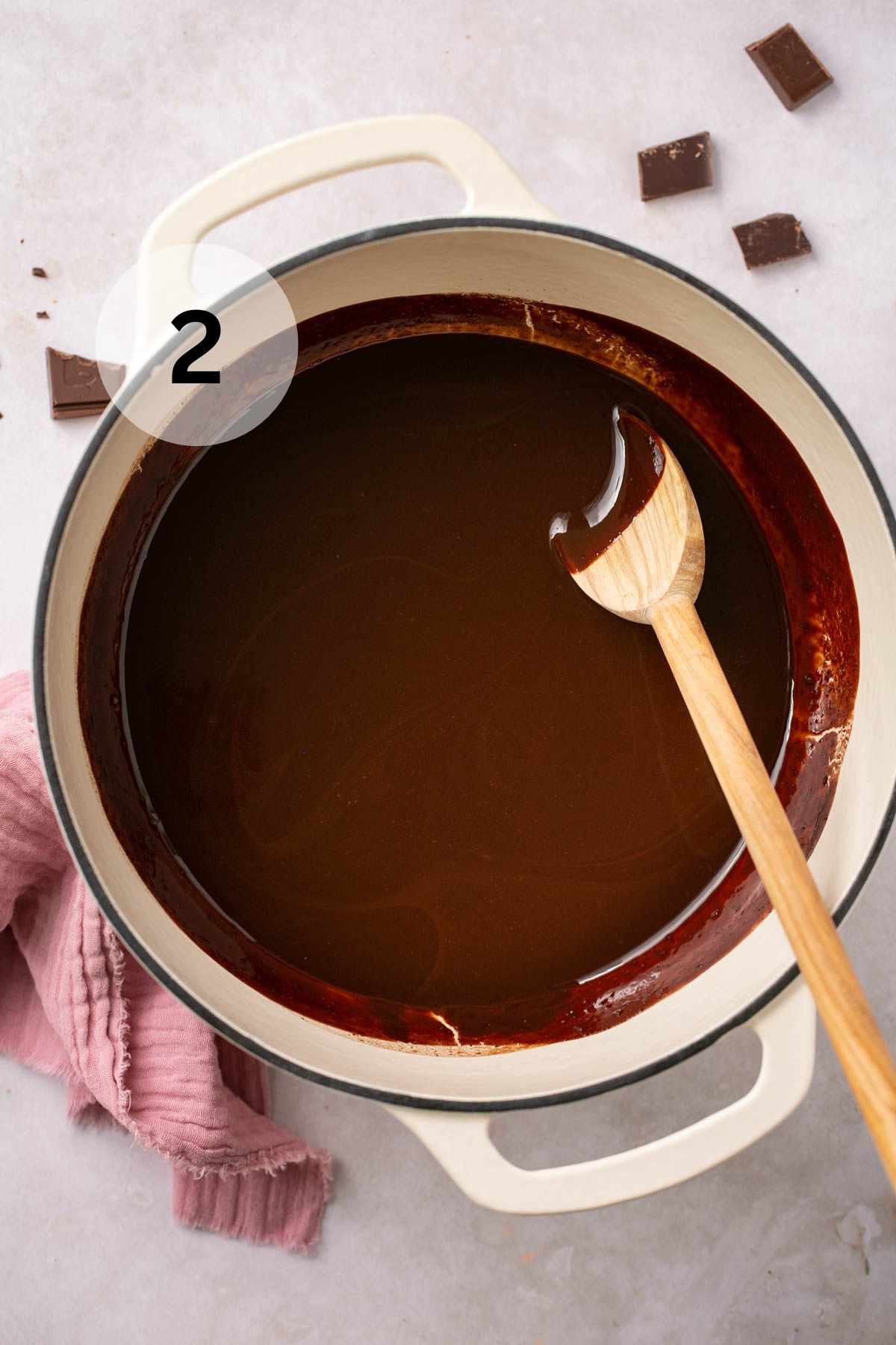 Stirring melted chocolate and butter with a wooden spoon.