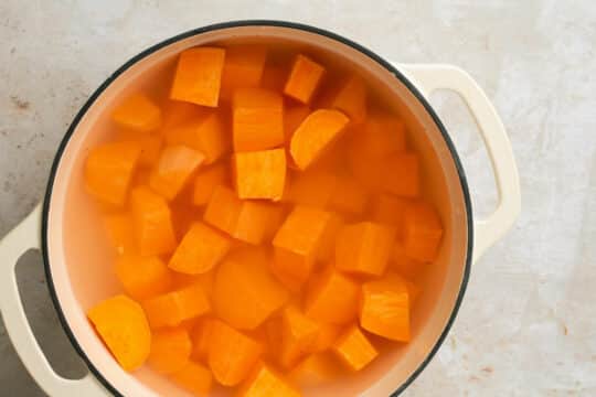 Cubed sweet potatoes in water in a pot.