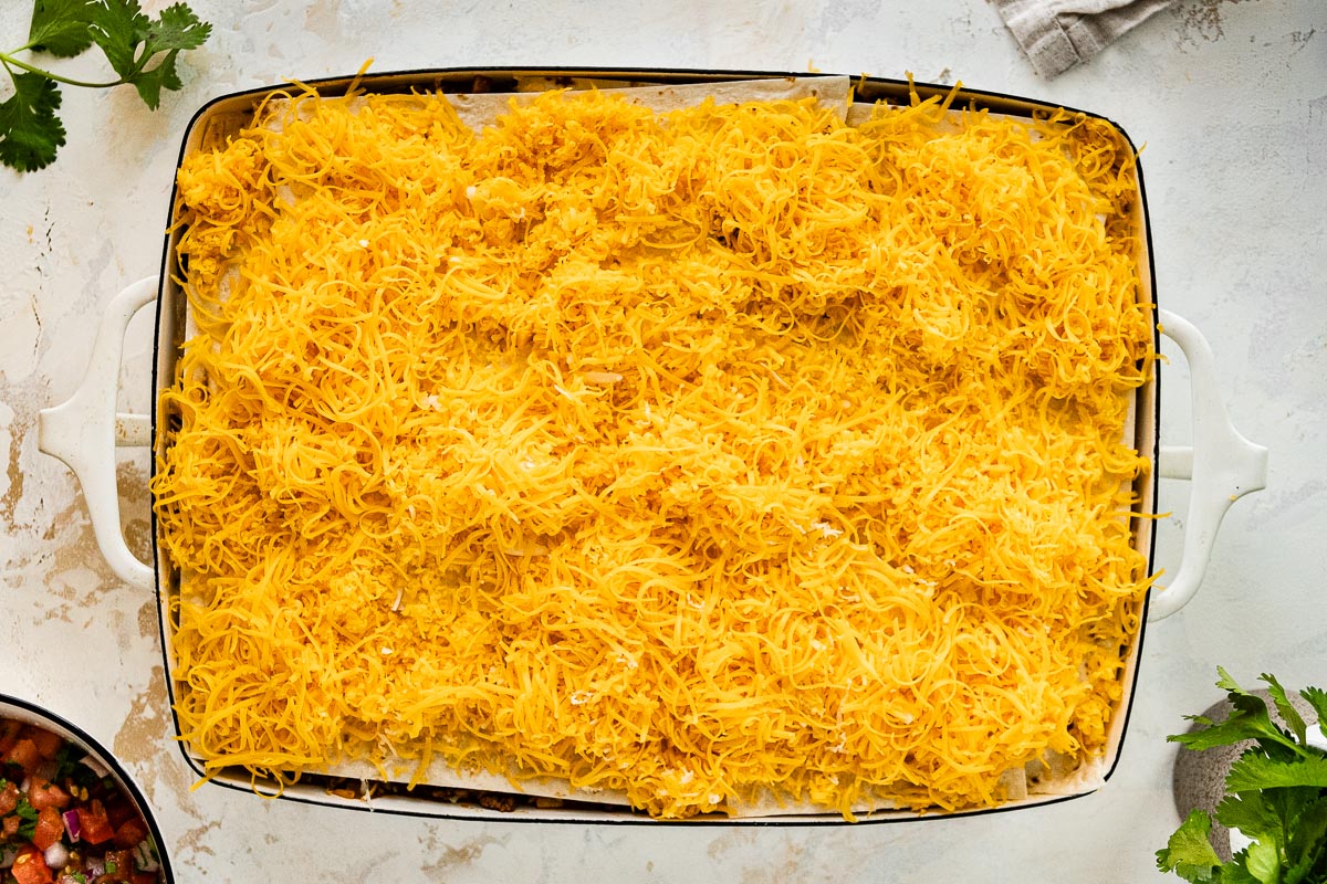 Cheese sprinkled over a Mexican casserole.