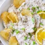 Potato chips dipped in clam dip.