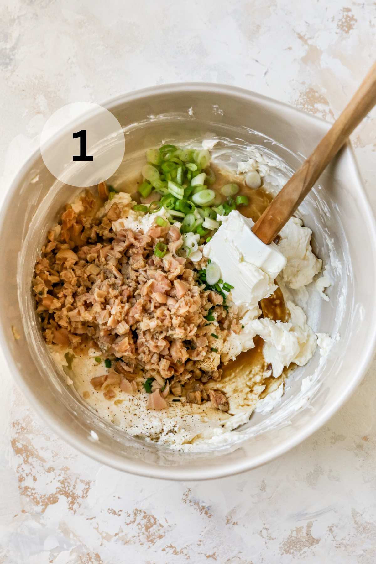 Stirring clams, green onions and cream cheese.