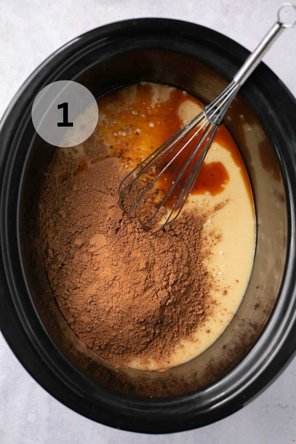 Whisking cocoa with sweetened condensed milk and vanilla.