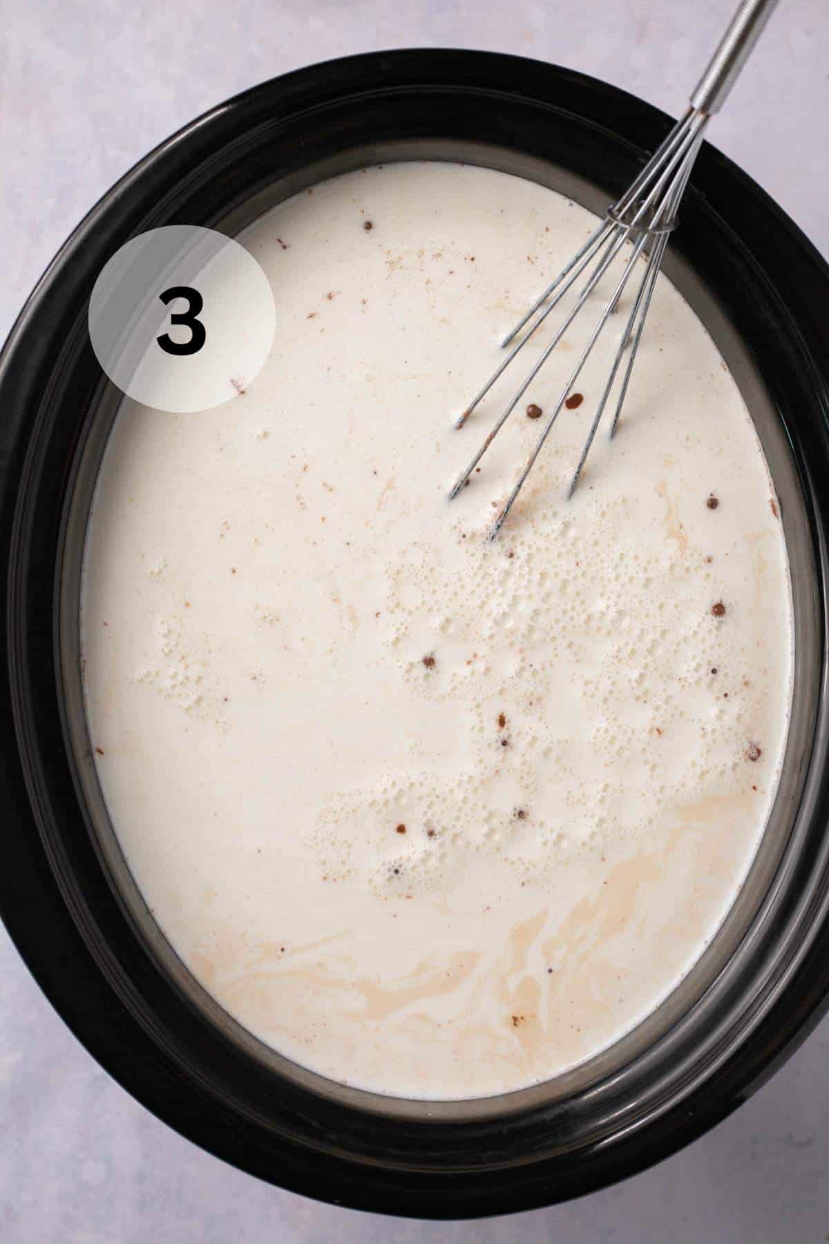 Adding milk to chocolate mixture in a slow cooker.