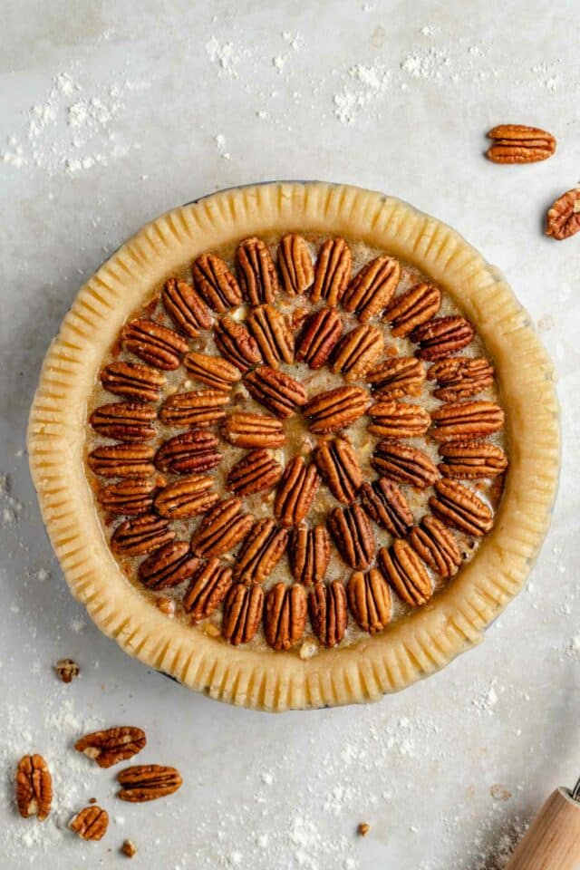 Filling poured into a crust and topped with pecans.