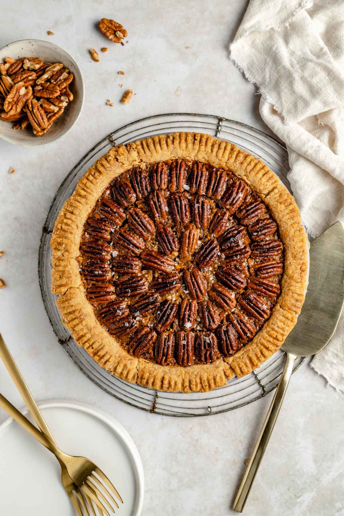 Homemade pecan pie on a wire rack.