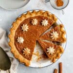 Sweet potato pie sliced in a pie dish.