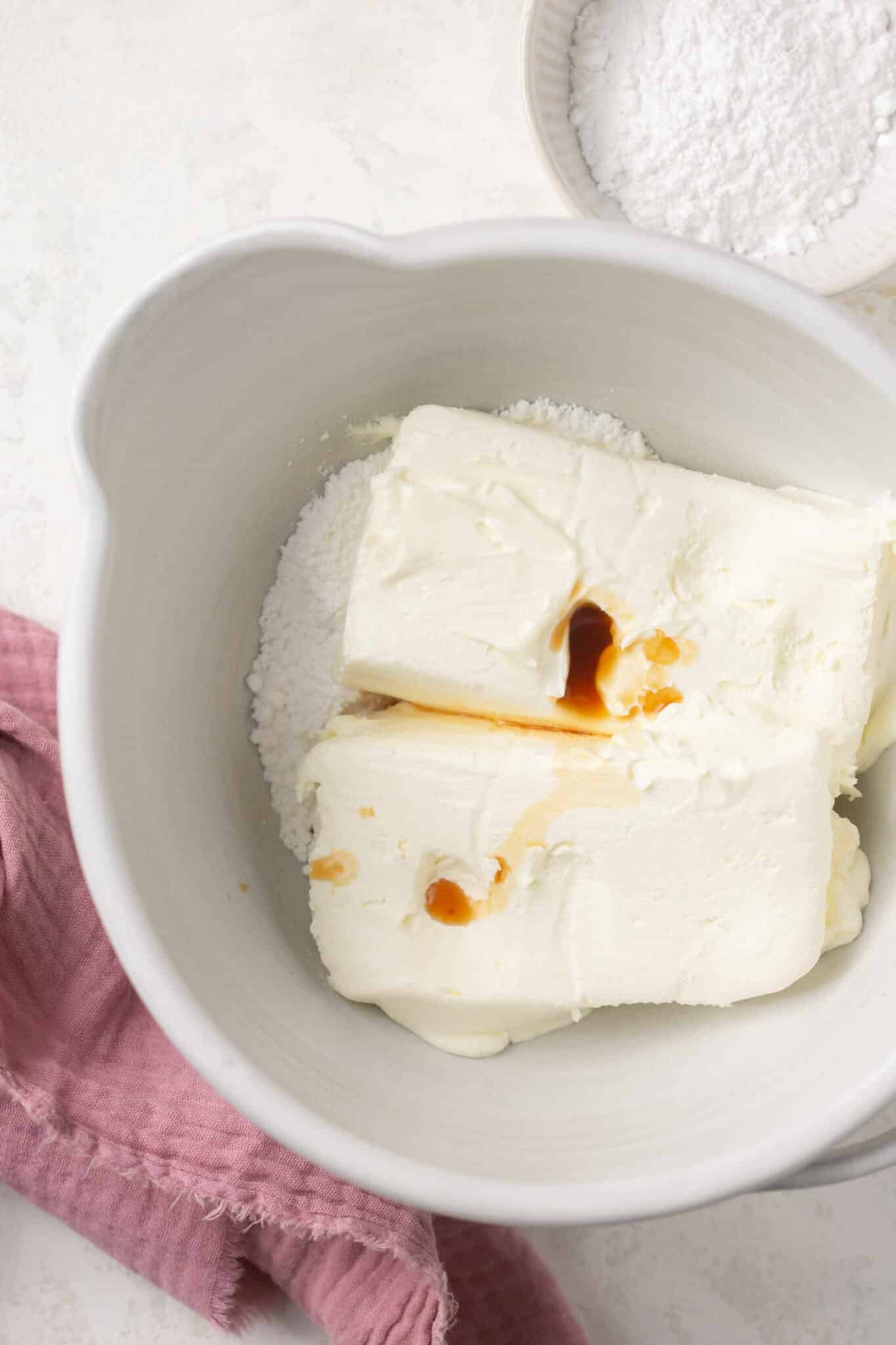 Cream cheese and vanilla in a bowl.