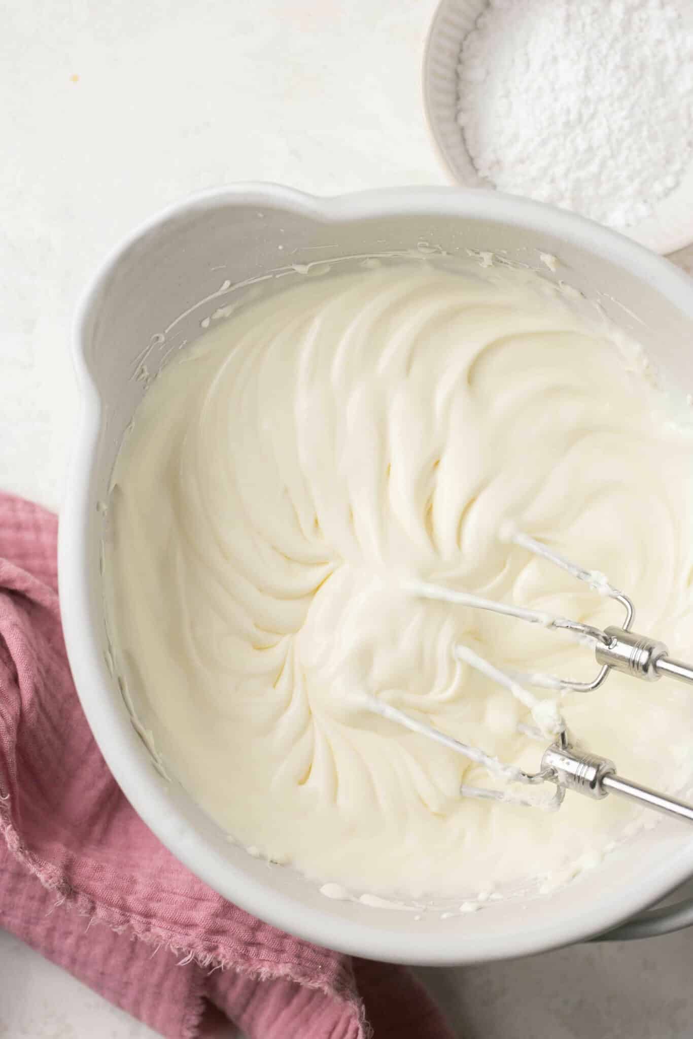 Whipping heavy whipping cream with cream cheese.