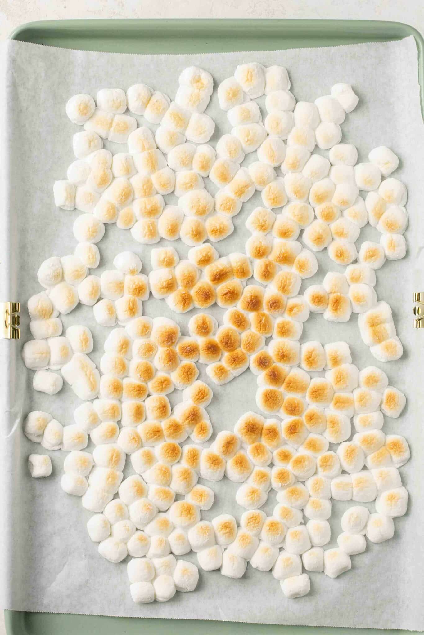 Toasted marshmallows on a baking sheet.