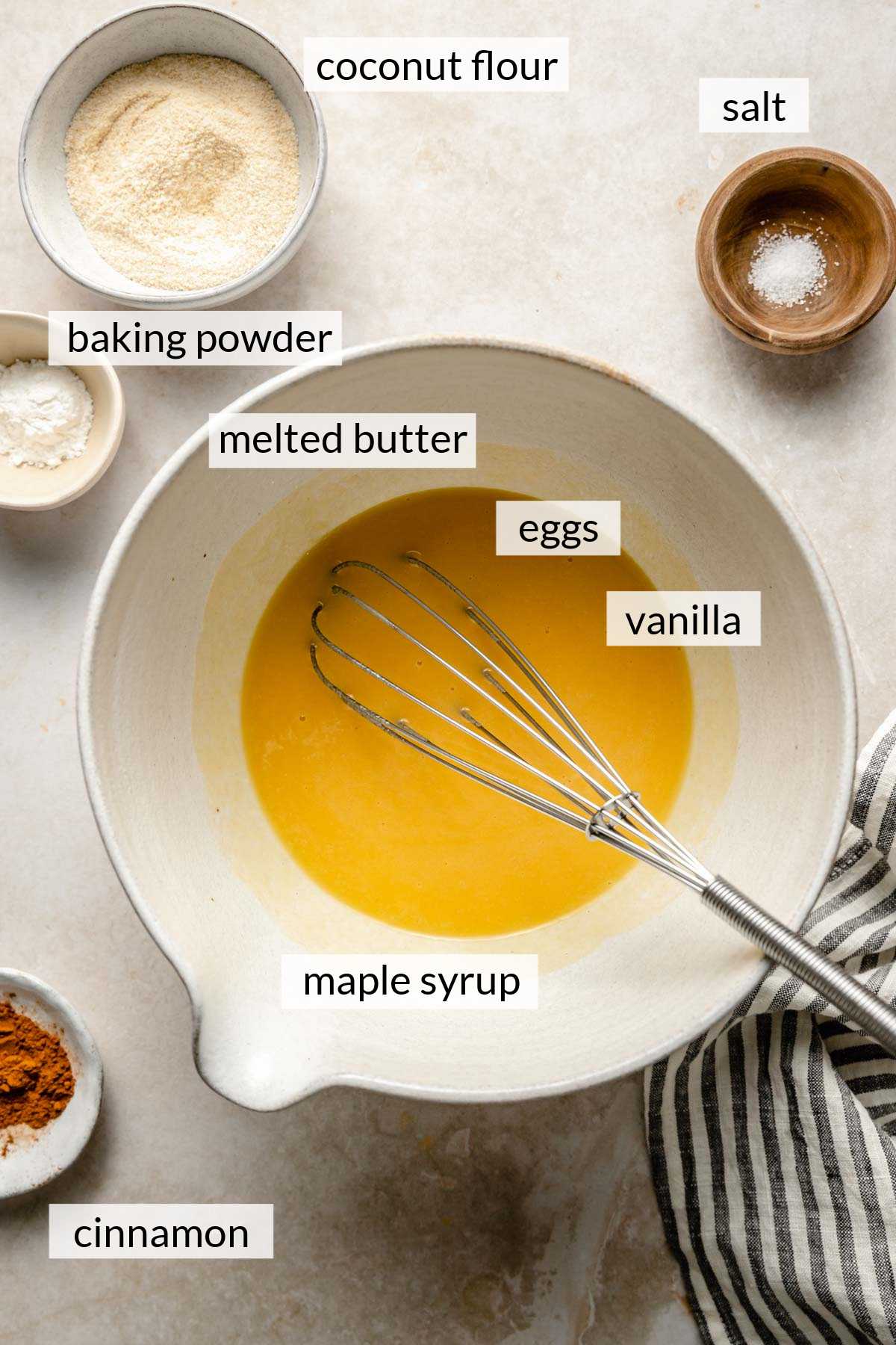 Melted butter in a bowl whisked with eggs, maple syrup, and vanilla.