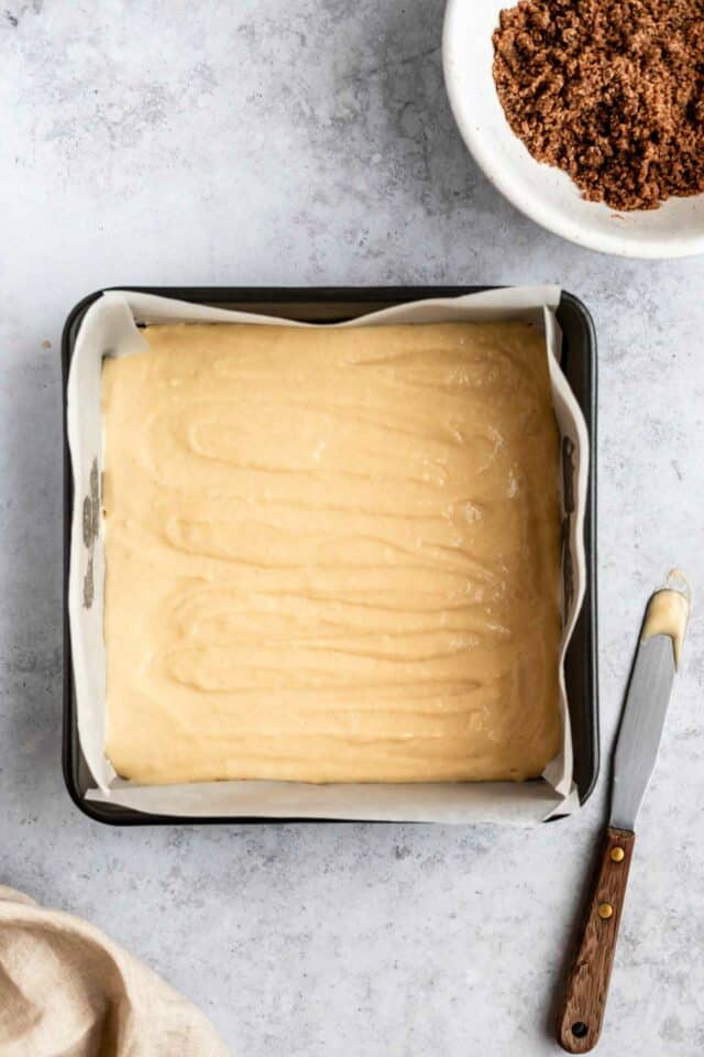 Spreading batter in pan.