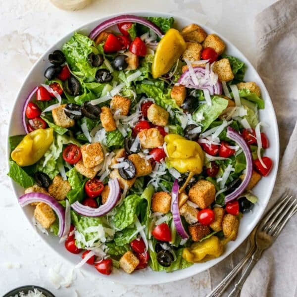 Italian salad served on a large white plate.